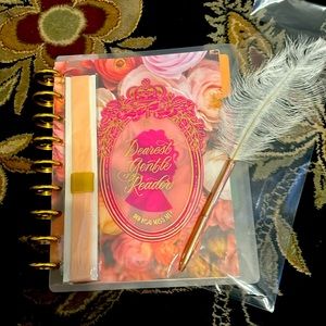 The Happy Planner Bridgerton notebook, pen, and elastic band.